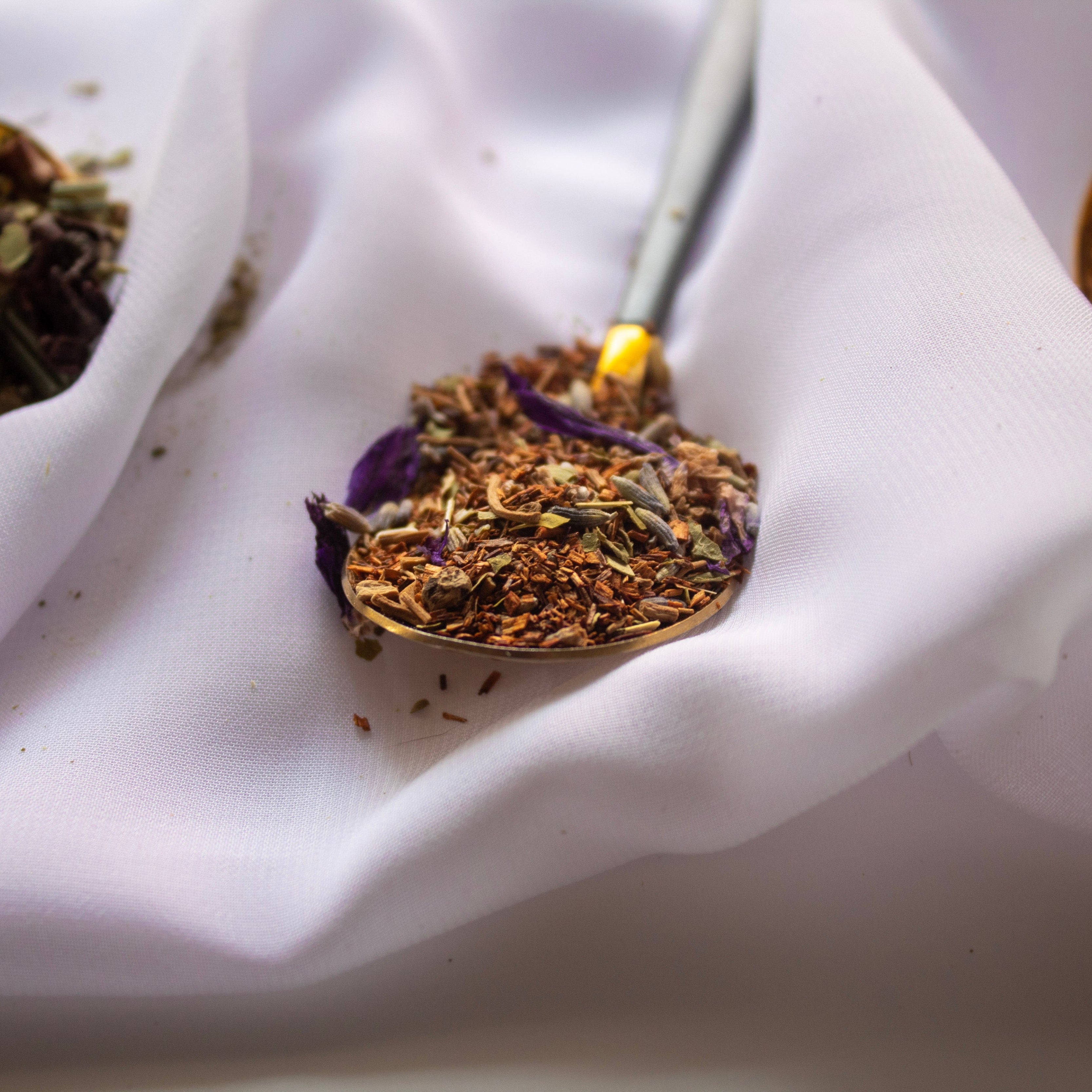Close-up of dried herbs on a white fabric background